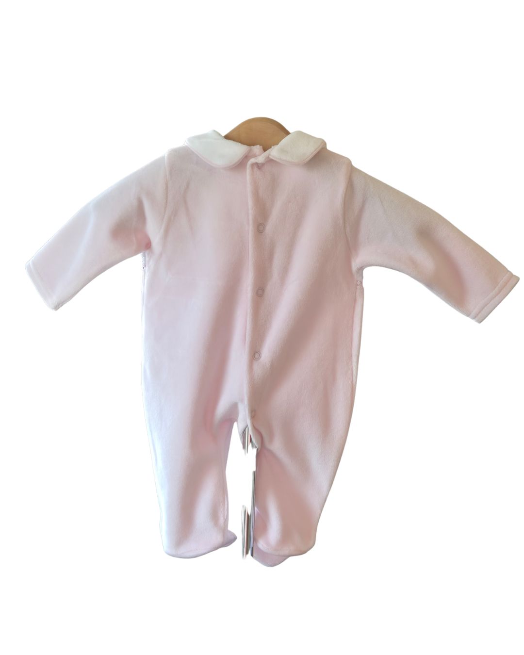 Pink velour baby sleepsuit with footed legs