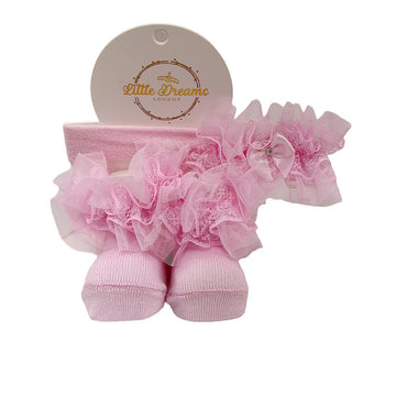 Pink baby socks and headband set with 'Little Dreams London' tag on a white background