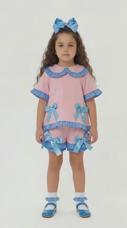 girls pink frill shorts and top set with blue bows