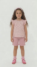 Girls dusky pink knee length shorts and floral floaty top summer outfit