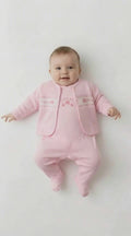 Cute baby in a pink romper with a crown and star on it and a jacket that is smocked with the words princess