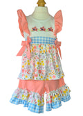 Colorful children's top and matching pedal pushers with floral and checkered patterns on a mannequin.
