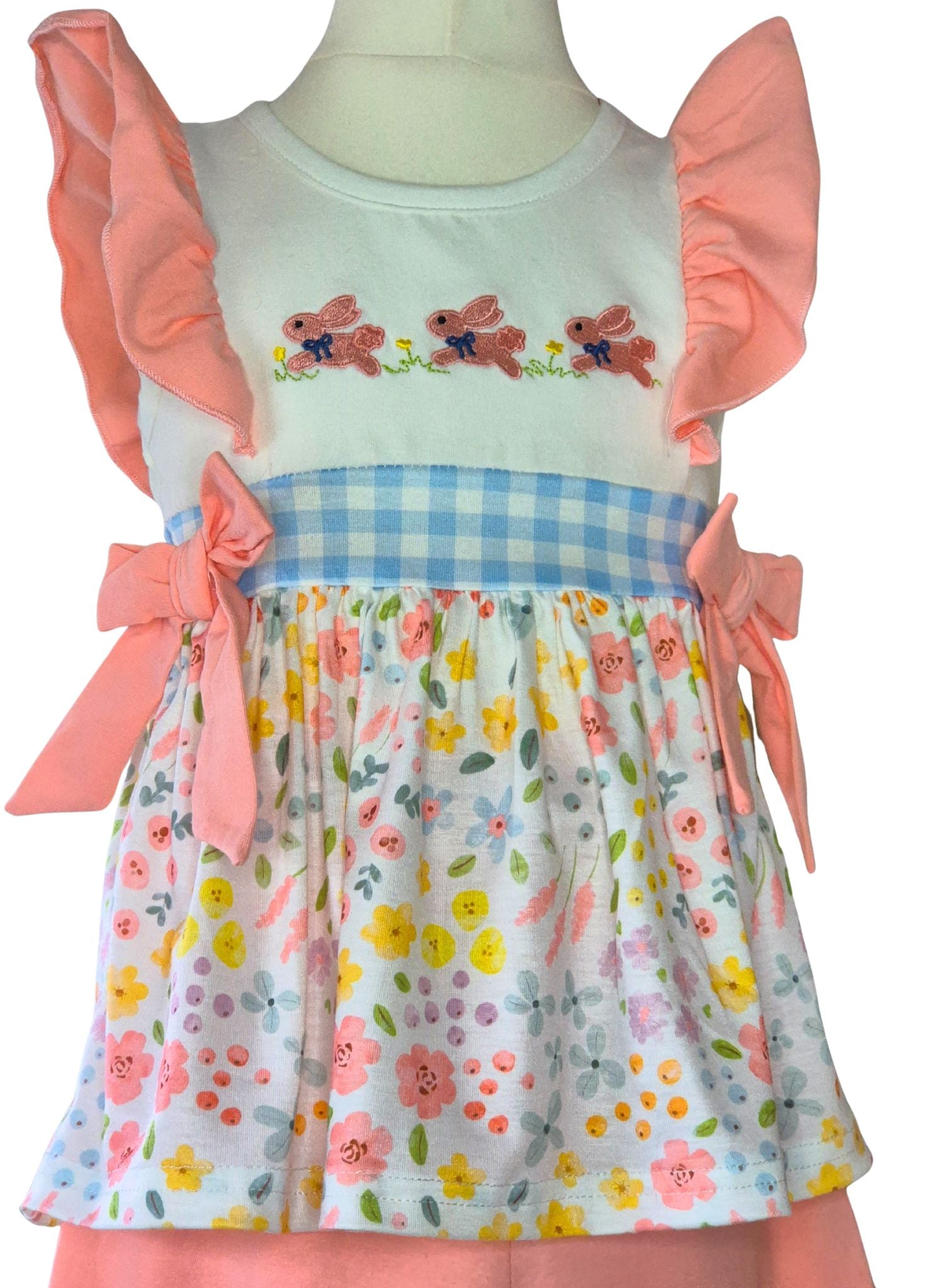 Children's top with floral skirt and embroidered top on a mannequin against a white background