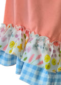 Set of colorful ruffle shorts with floral and checkered patterns on a pink background.