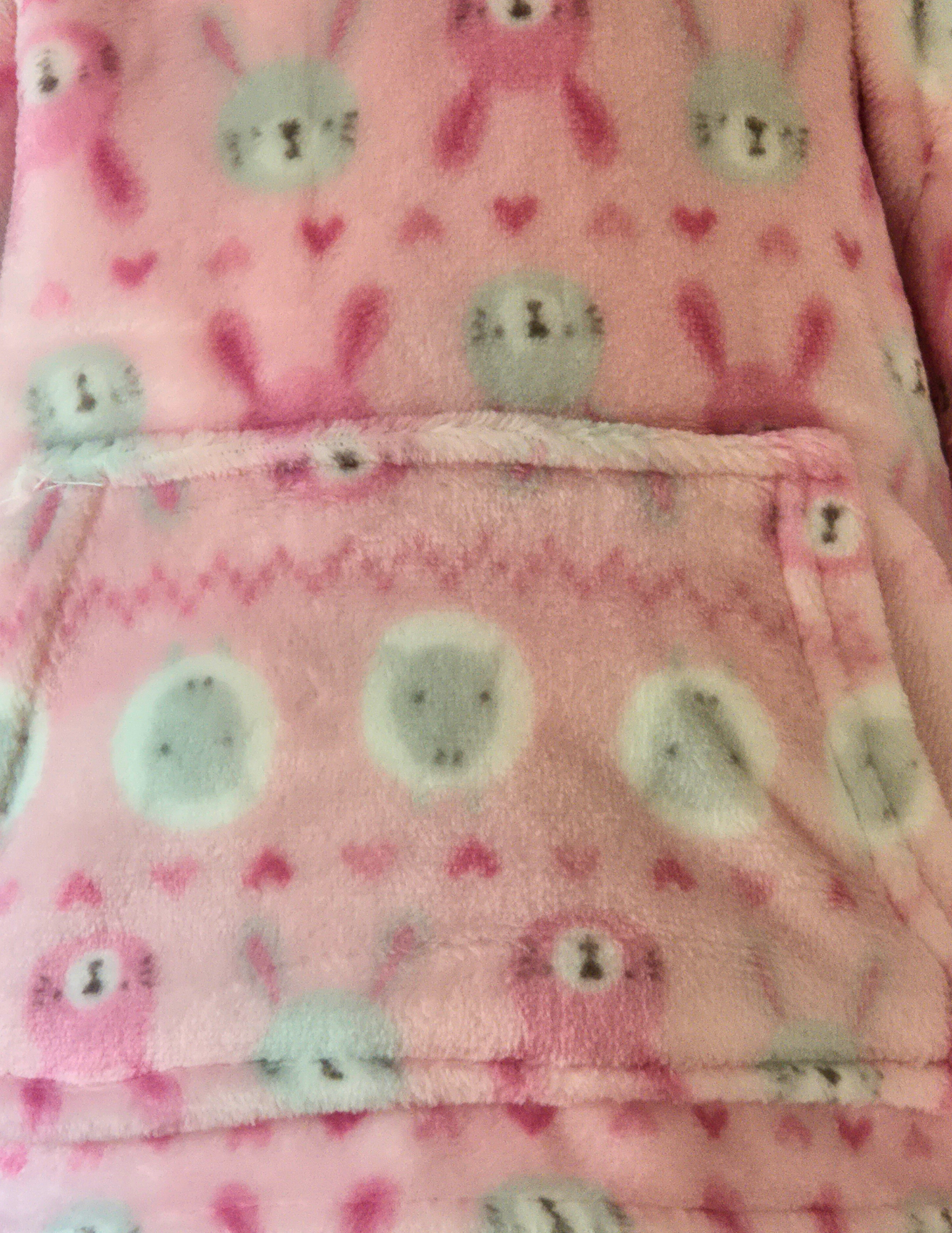 Pink fleece material with rabbits and sheep 