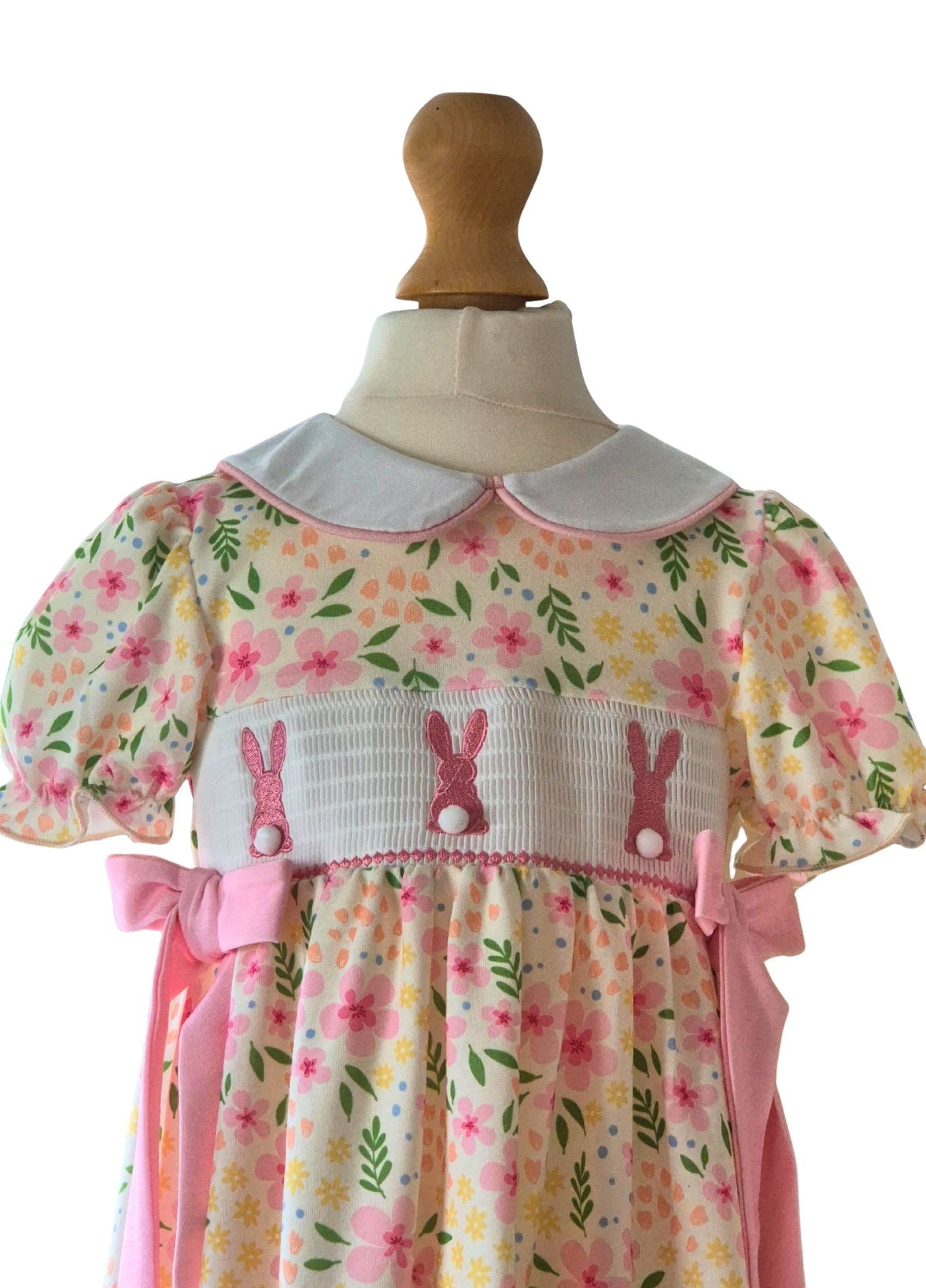 Floral dress with bunny design on a mannequin against a white background