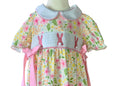 Babys romper with floral and bunny pattern on a mannequin against a white background