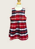Red, white, and blue plaid dress on a mannequin against a plain background