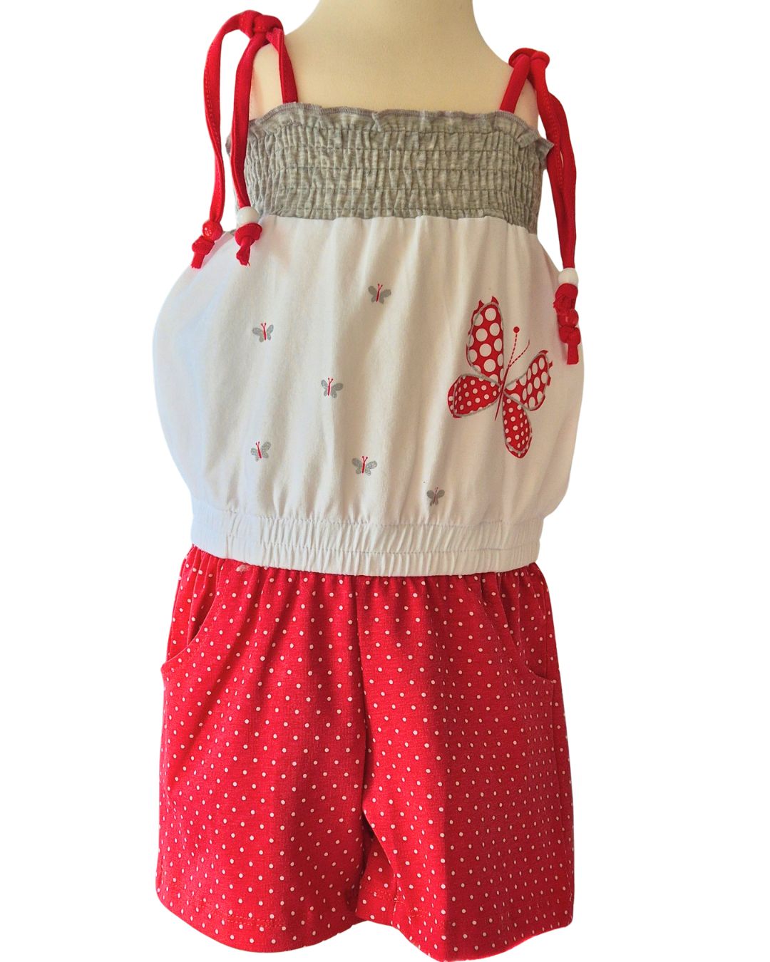 Children’s red polka dot summer playsuit with butterfly detail