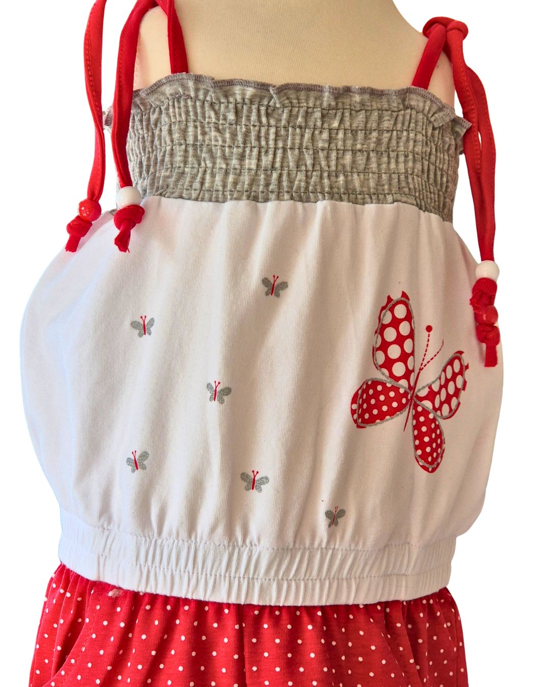 Red polka dot playsuit with tie straps and bead detail