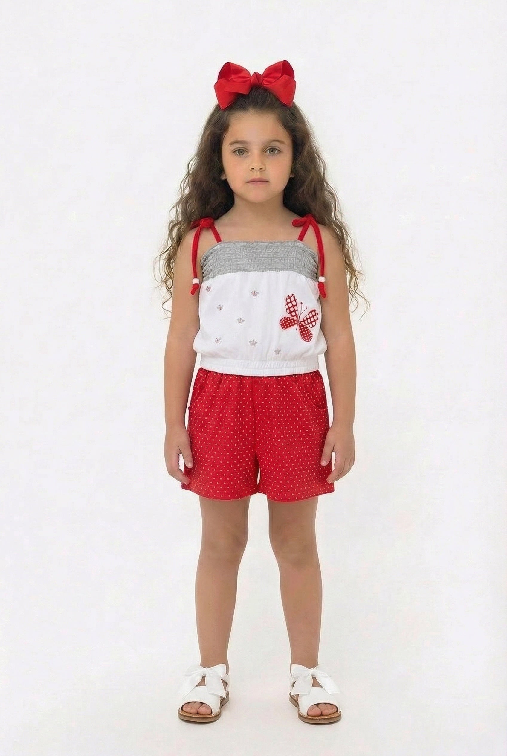 Children’s red polka dot summer playsuit with butterfly detail