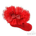 Red baby sock with tutu tulle frill and bow on a white background