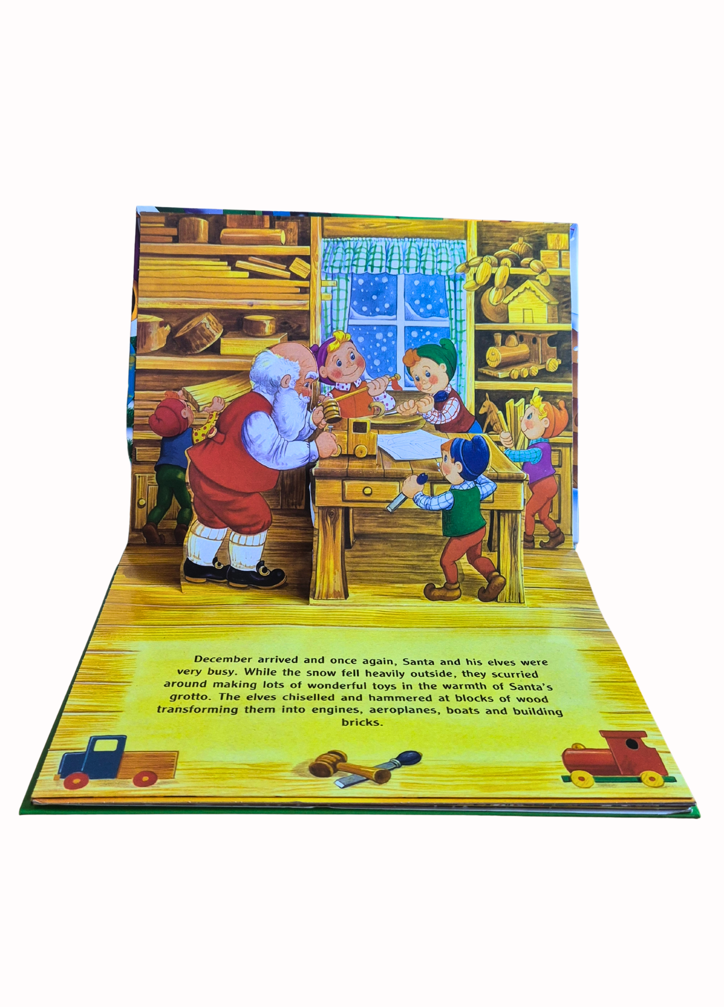 Pop-up book page with Santa Claus and elves in a workshop