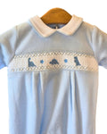 Sky blue velour baby sleepsuit with embroidered dinosaur design