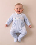 Boys sky blue velour dinosaur sleepsuit with embroidered dinosaurs and stars