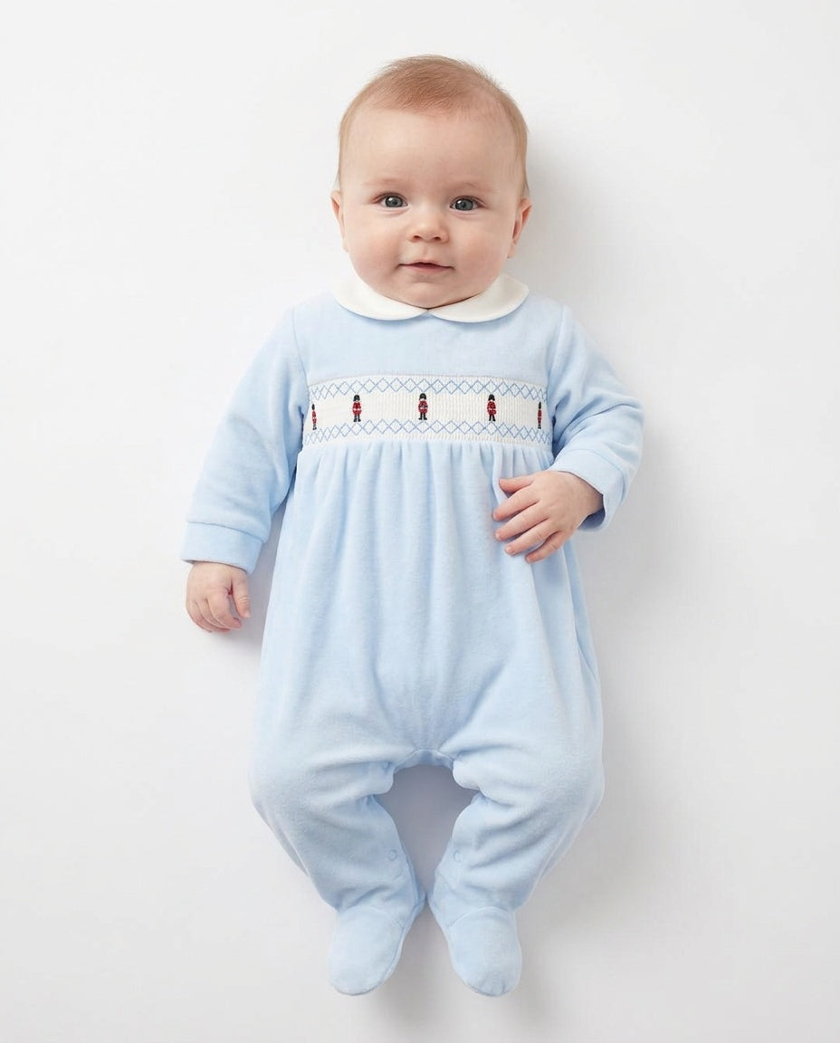 Kleo Kids sky blue velour smocked soldiers sleepsuit with red-uniform embroidery and white Peter Pan collar