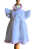 White dress with pink trim on a mannequin against a white background