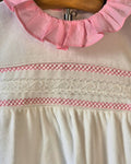 Baby white and pink sleepsuit with smocked chest detail