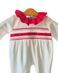 Baby sleepsuit with red lace chest and sleeve detailing