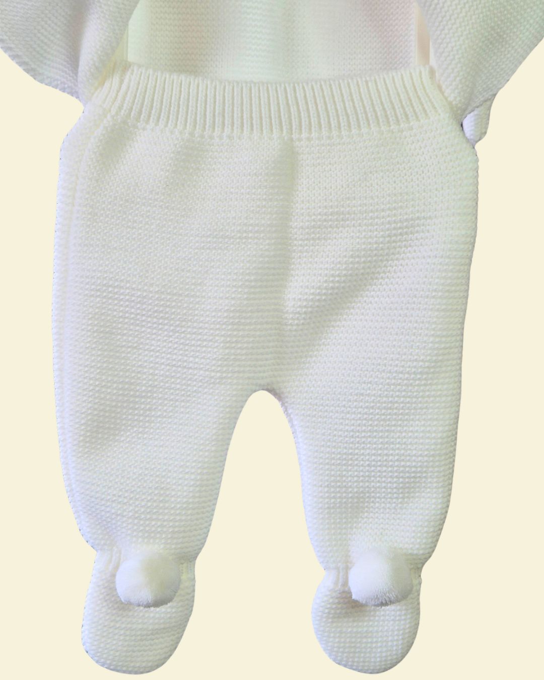 Newborn white knitted trousers with pom pom feet